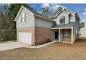 Side view of charming two-story home with a two-car garage and brick accents at 2704 River Summit Ln, Decatur, GA 30034