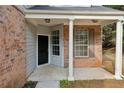 Inviting front porch with brick accents, white columns, and a view of the front yard at 2704 River Summit Ln, Decatur, GA 30034