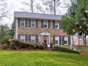 Attractive brick two-story home with a well-maintained lawn, an American flag, and a welcoming red front door at 2751 Davis Rd, Marietta, GA 30062