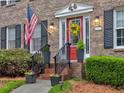 Close-up of the charming entryway features a red door, sidelights, and tasteful landscaping at 2751 Davis Rd, Marietta, GA 30062