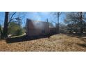 The backyard has a lot of leaves with a view of the house at 3005 Flat Shoals Rd, Atlanta, GA 30349