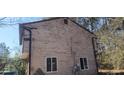 The side of the house and showing peeled paint, a window, and vines growing at 3005 Flat Shoals Rd, Atlanta, GA 30349