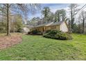 Well-maintained home exterior with manicured lawn and lush greenery, offering a serene setting at 921 Forest Park Ln, Suwanee, GA 30024