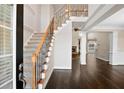 Elegant foyer featuring hardwood floors, a staircase with iron railings, and an open layout at 2778 Macland Rd, Dallas, GA 30157