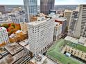 View of a multi-story building with surrounding fall foliage in a city landscape with more skyscrapers in the distance at 57 Forsyth Nw St # 14D, Atlanta, GA 30303