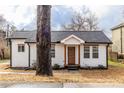 Beautifully renovated single-story home with crisp white siding, new roof and wood trim at 1466 Venetian Sw Dr, Atlanta, GA 30311