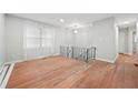 Bright living room featuring hardwood floors and a staircase with iron railing at 6605 Black Bend Ct, Riverdale, GA 30274