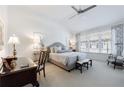 Serene bedroom featuring a large window, ceiling fan, and neutral decor at 3101 Howell Mill Nw Rd # 327, Atlanta, GA 30327