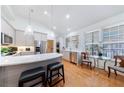 Well-lit kitchen boasts stainless steel appliances, a breakfast bar with seating, and gleaming hardwood floors at 3101 Howell Mill Nw Rd # 327, Atlanta, GA 30327