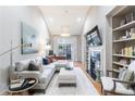 Inviting living room features a cozy fireplace, built-in shelving, and neutral decor with outside views at 3101 Howell Mill Nw Rd # 327, Atlanta, GA 30327