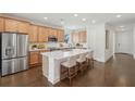 Bright and airy kitchen with stainless steel appliances and large island with seating at 615 Grassmeade Ln, Woodstock, GA 30188