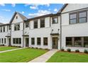 Charming new construction townhomes with white brick and siding, complemented by lush green lawns and professional landscaping at 1322 Parc Bench Rd, Atlanta, GA 30316
