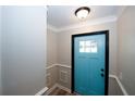 Bright and welcoming entryway with a stylish blue door and modern trim work at 1616 W Kellogg Cir, Douglasville, GA 30134