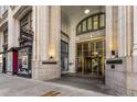 A detailed view of the building's entrance with brass doors, historical signage, and stone columns at 57 Forsyth Nw St # 9G, Atlanta, GA 30303