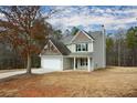 Attractive two-story home featuring a two-car garage and classic architectural details at 111 Jackson Farms Dr, Rockmart, GA 30153