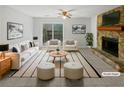 Bright living room with stone fireplace, ceiling fan, and sliding glass doors to the yard at 5808 Trent Walk Dr, Lithonia, GA 30038
