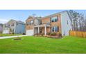 Attractive two-story home showcases a brick facade, a well-groomed lawn, and a two-car garage at 2713 Serena Way, South Fulton, GA 30331