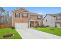 Charming two-story brick home featuring a well-kept lawn and a spacious two-car garage at 2713 Serena Way, South Fulton, GA 30331
