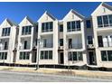 Modern townhome exterior featuring brick facade, balconies, and large windows for abundant natural light at 2637 Mackintosh Ct # 8, Brookhaven, GA 30319