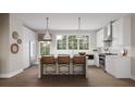 Bright kitchen featuring white cabinetry, an island with seating, and stainless steel appliances at 2637 Mackintosh Ct # 8, Brookhaven, GA 30319