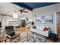 Inviting living room with a unique blue ceiling, modern furniture, hardwood floors, and plenty of natural light at 3180 Vine Cir, Decatur, GA 30033