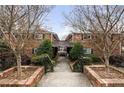 Charming brick building with landscaped walkway and mature trees, offering a welcoming facade and curb appeal at 343 8Th Street Ne # E2, Atlanta, GA 30309