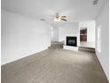 Spacious, carpeted living room with fireplace and neutral color scheme at 4441 Prather Son Dr, Loganville, GA 30052