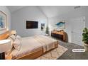 Well-lit main bedroom featuring a vaulted ceiling and modern furnishings at 4441 Prather Son Dr, Loganville, GA 30052