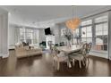 Bright and airy living room with hardwood floors, fireplace, modern lighting, and large windows at 545 Hanlon Way, Alpharetta, GA 30009