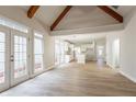 Open concept living space with a view of the kitchen, featuring abundant natural light and wood floors at 1521 Reids Ferry Way, Marietta, GA 30062