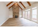 Inviting living room with a stone fireplace, vaulted ceilings, exposed wood beams, and large windows at 1521 Reids Ferry Way, Marietta, GA 30062