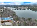 Aerial view of lakefront home near Bald Ridge Marina with mature trees and beautiful location at 4110 Sinclair Shores Rd, Cumming, GA 30041