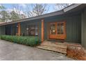 Inviting front entrance with a wooden double-door, stone steps, and manicured greenery at 4230 N Elizabeth Se Ln, Atlanta, GA 30339