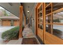 Inviting front porch featuring wooden beams, stone flooring, and elegant wooden double-doors at 4230 N Elizabeth Se Ln, Atlanta, GA 30339