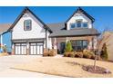 Charming two-story home featuring a two-car garage and manicured lawn at 515 Windy Ridge Ct, Canton, GA 30114