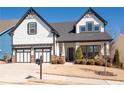 Charming two-story home featuring a two-car garage and manicured lawn at 515 Windy Ridge Ct, Canton, GA 30114