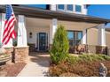 Inviting front porch with stone accents and an American flag at 515 Windy Ridge Ct, Canton, GA 30114