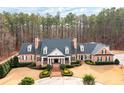 Charming two-story brick home with symmetrical design, dormer windows and lush landscaping at 3201 Hobsons Ridge Nw Trl, Acworth, GA 30101