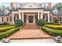 Grand entrance showcasing brick steps, a covered porch with columns and manicured landscaping at 3201 Hobsons Ridge Nw Trl, Acworth, GA 30101