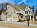 This home features a side-entry garage, a neutral color scheme and a well-kept lawn at 4188 Gunnerson Ln, Kennesaw, GA 30152