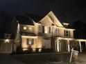 Exterior home view at night with brick and siding, manicured yard, and a For Sale sign displayed at 4188 Gunnerson Ln, Kennesaw, GA 30152