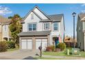 Beautiful two-story home boasts manicured lawn and a convenient two-car garage at 5835 Sterling Ct, Cumming, GA 30040