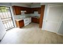 Bright kitchen with wooden cabinets, white appliances, and access to an outdoor area at 2660 Evans Mill Dr, Lithonia, GA 30058