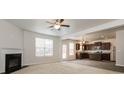 Open-concept living space with fireplace flows into modern kitchen featuring stainless steel appliances at 4924 Rapahoe Trl, Atlanta, GA 30349