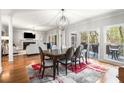 Open floor plan showcasing dining area with hardwood floors, a rug, and large windows at 1255 Wildcliff Ne Pkwy, Atlanta, GA 30329