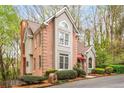 Brick home exterior featuring manicured shrubs and a brick mailbox in a wooded area at 1255 Wildcliff Ne Pkwy, Atlanta, GA 30329