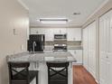 Well-lit kitchen features white cabinets, granite countertops, and stainless steel appliances at 1371 Keys Lake Ne Dr, Brookhaven, GA 30319