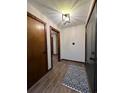 Inviting entryway with modern light fixture, new front door and attractive hardwood floors at 1449 Albans Ct, Lithonia, GA 30058