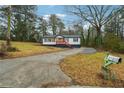 A quaint home with a well-maintained lawn and a long driveway leading to a mailbox at 2595 Old Toney Rd, Ellenwood, GA 30294