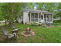 View of the backyard with fire pit and seating area for outdoor living at 1610 Elm Ne St, Conyers, GA 30012